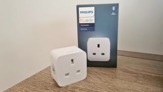 Philips Hue Smart Plug shown on wooden side table