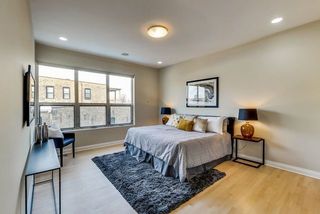 A simple and spacious master bedroom with waxy wooden flooring