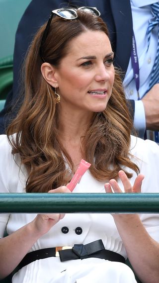 Kate Middleton holds a Clarins Instant Light Lip Perfector at Wimbledon