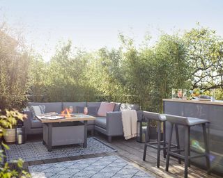 Natural Zen Astrid sofa from Dobbies with bar on decking