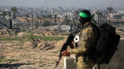 A Hamas soldier stands guard in Khan Yunis in the Gaza Strip