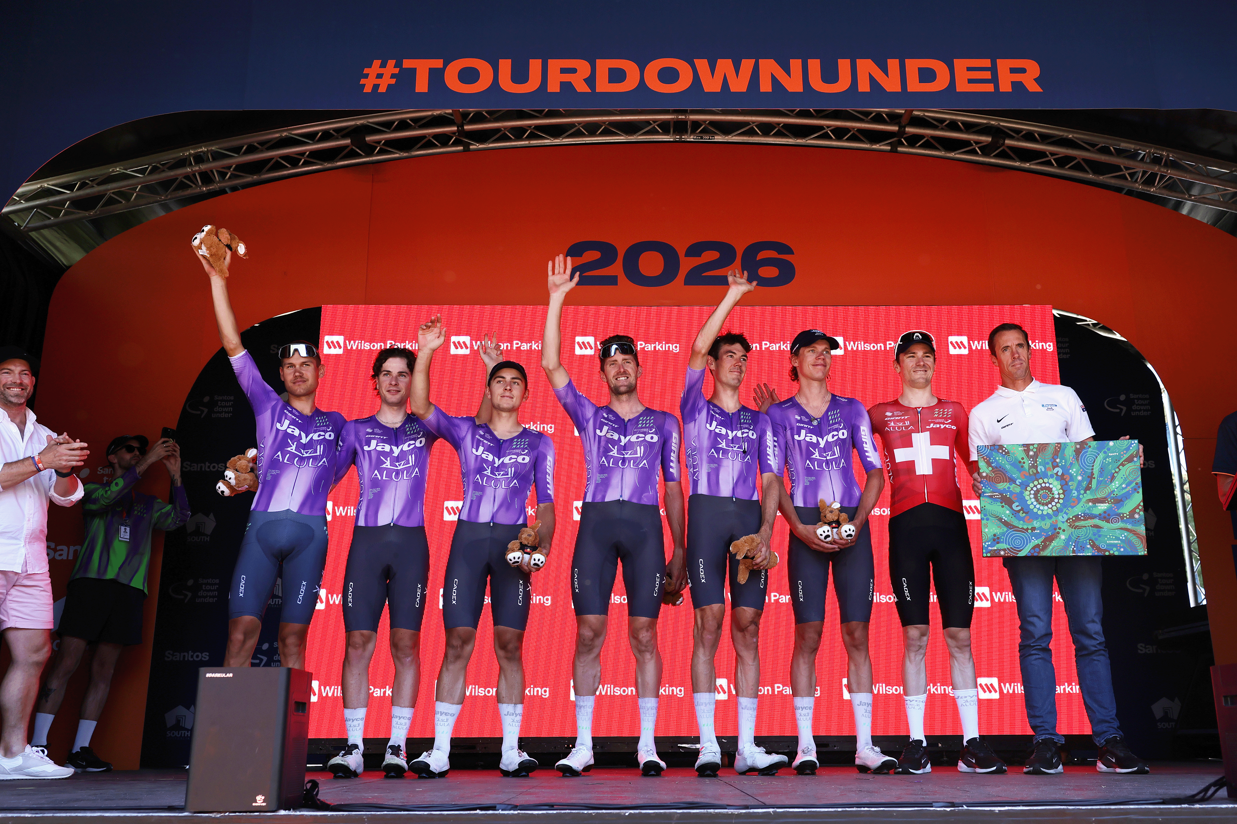 STIRLING, AUSTRALIA - JANUARY 25: Ben O'Connor of Australia, Luke Durbridge of Australia, Rudy Porter of Australia, Hamish McKenzie of Australia, Kelland O'Brien of Australia, Luke Plapp of Australia, Mauro Schmid of Switzerland and Team Jayco AlUla celebrate at podium as best team prize winners during the 26th Santos Tour Down Under 2026, Stage 5 a 169.8km stage from Stirling to Stirling / #UCIWT / on January 25, 2026 in Stirling, Australia. (Photo by Con Chronis/Getty Images)