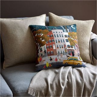 City Trick or Treat Pillow Cover Set on a sofa seat.