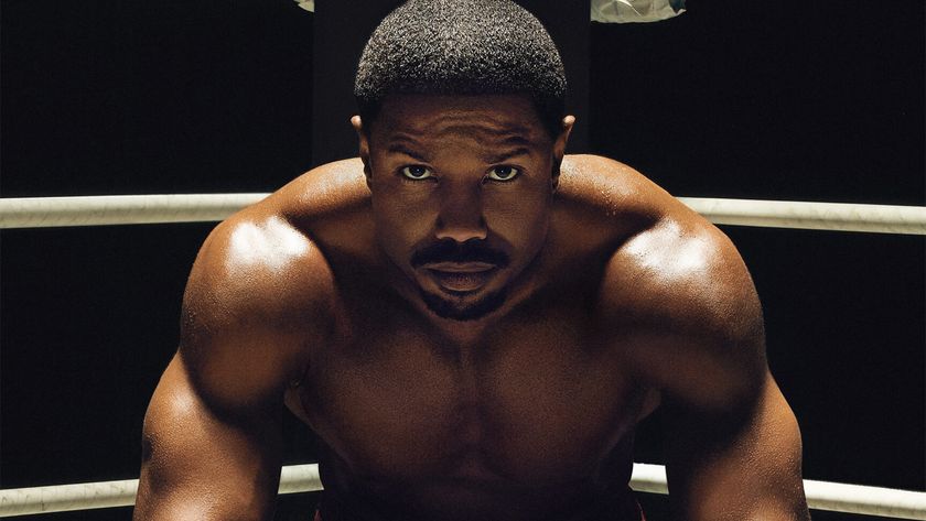 Michael B. Jordan as Adonis Creed, sitting in the corner of a boxing ring