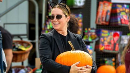 Ashley Tisdale holding a pumpkin