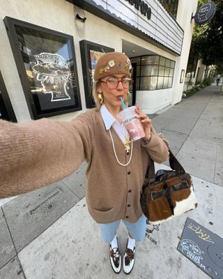 Autumn Microtrends 2024:  @sofiamcoelho wears a pair of cow-print loafers with a beige cardigan