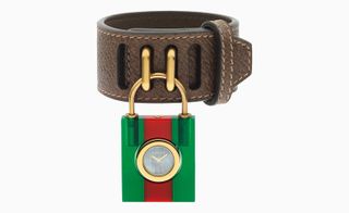 Green and red padlock, shackled to a dark brown leather strap