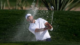 Scottie Scheffler of the United States hits from a green side bunker at the Waste Management Open