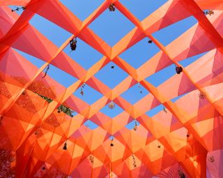 orange grid detail in a pavilion at chicago sukkah design festival