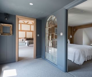 blue bedroom in Border Oak house with internal window