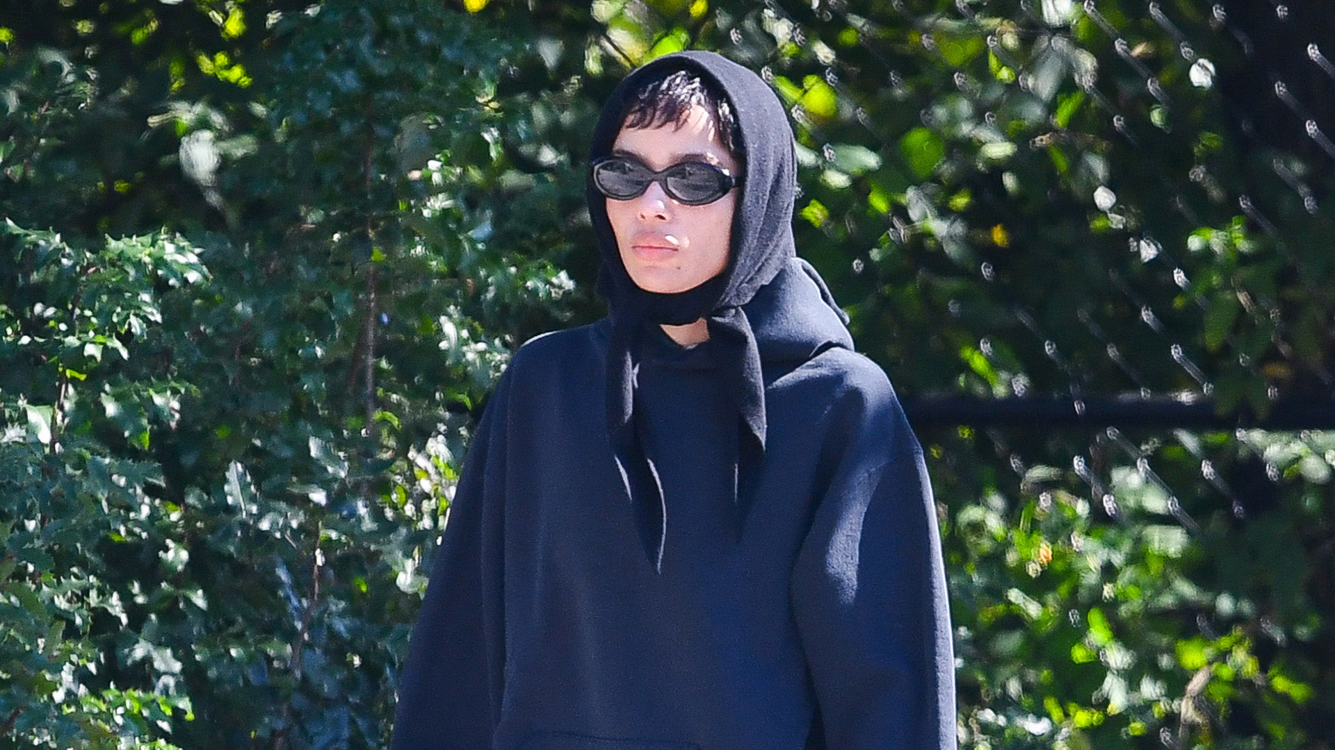 Zoë Kravitz wearing a navy sweatshirt, brown corduroy pants, and black Vans sneakers in NYC