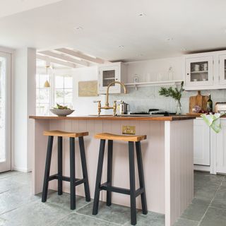 Kitchen with island and sink and bar stools