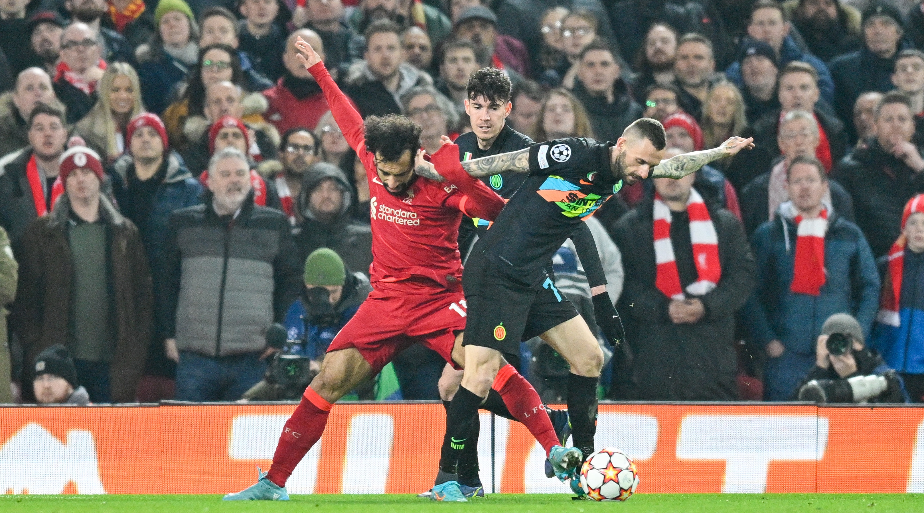 Mohamed Salah of Liverpool and Marcelo Brozovic of Inter Milan challenge for the ball during the UEFA Champions League match between Liverpool and Inter Milan on March 8, 2022 at Anfield, Liverpool, UK