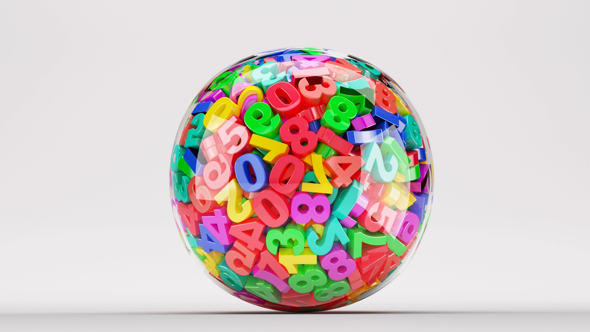 A clear ball containing lots of colourful plastic numbers