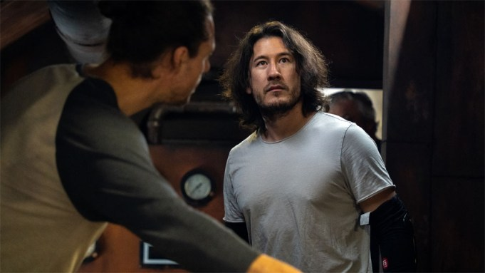 Markiplier in Iron Lung, with another man in front of him showing him something