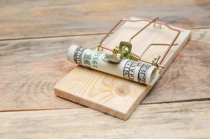 mouse trap with rolled up currency in it