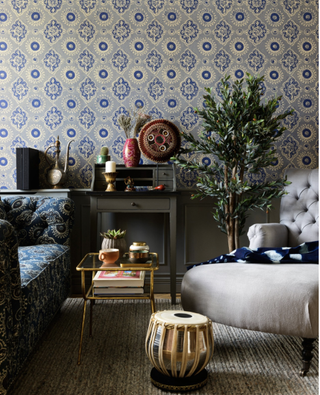 Blue printed wallpaper with large indoor tree and chaise longue