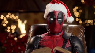 Deadpool in a santa hat holding a book