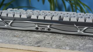 A gray GravaStar Mercury K1 Pro mechanical keyboard, with spider legs