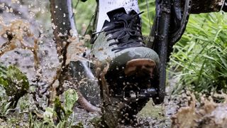 Shimano M520 pedal and S-Works Recon shoe in a muddy puddle