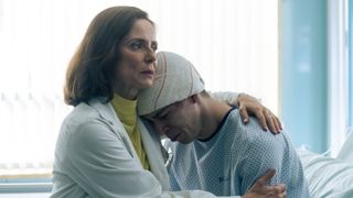 Dr Amaro comforts her son, Oscar, in the hospital