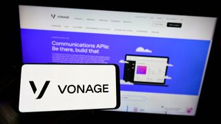 Person holding smartphone with logo of US cloud company Vonage Holdings Corp on screen in front of website Focus on phone display