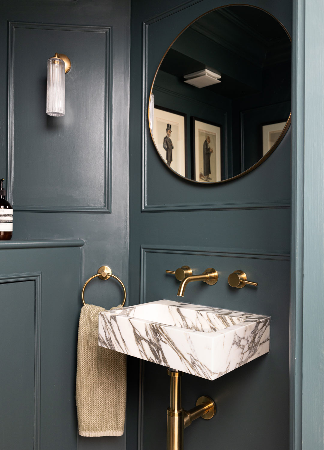 small dark grey cloakroom with wall-hung marble basin