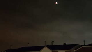 A reader in Ottawa, Canada took a picture of the lunar eclipse over the rooftops on May 15, 2022.