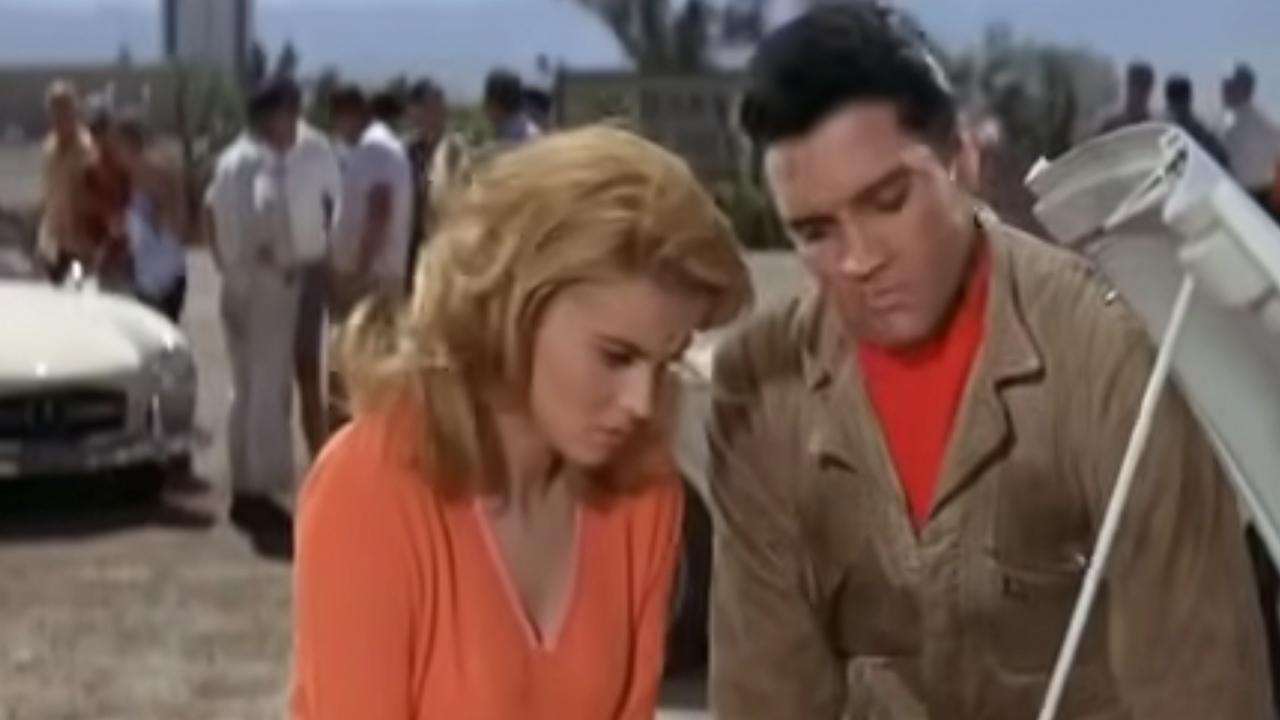 Elvis and a woman inspecting a car engine in Viva Las Vegas