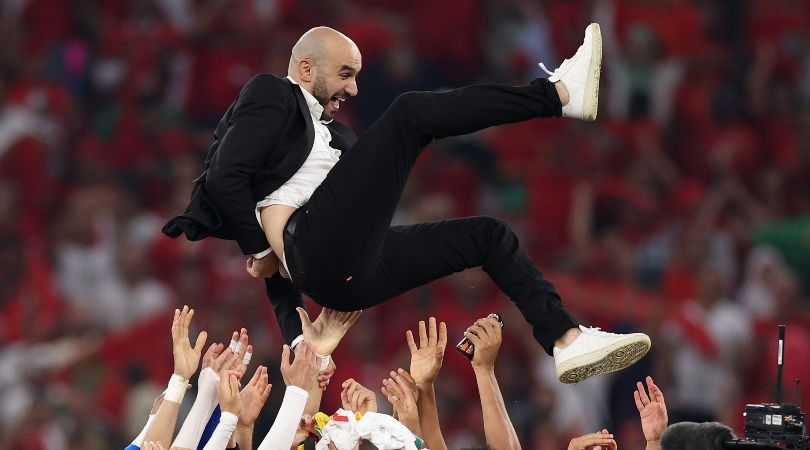 Morocco coach Walid Regragui is given the bumps by his players after the win over Canada which sealed their place in the last 16 of the 2022 World Cup.