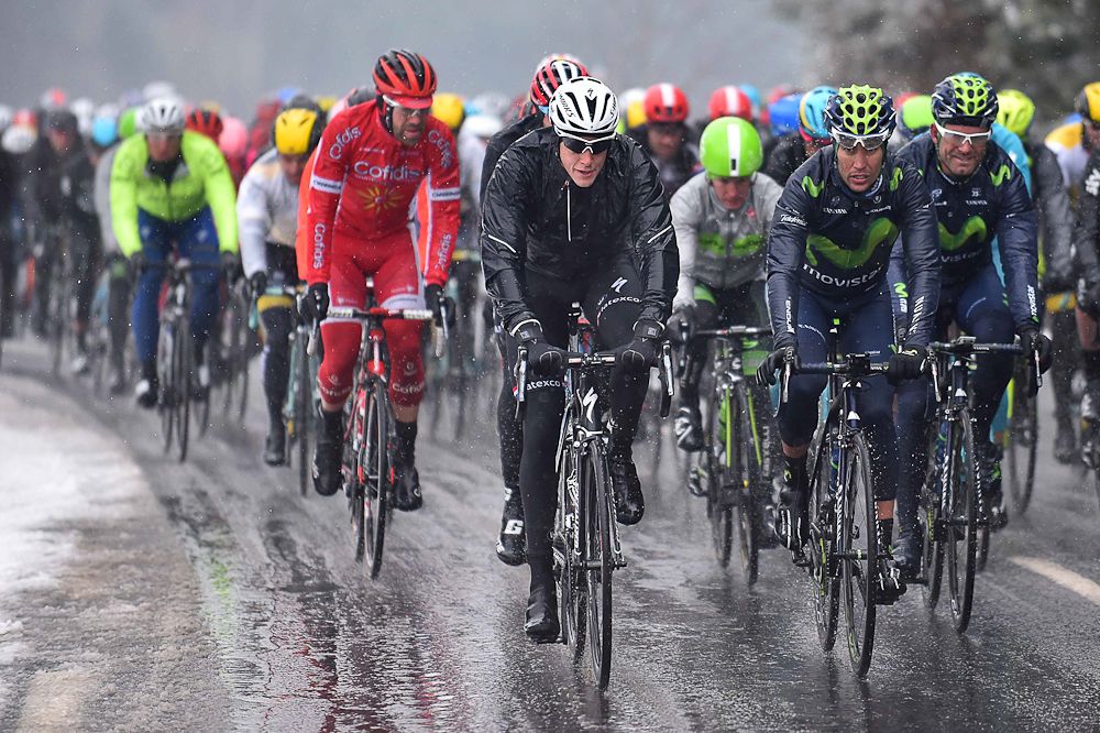 Riders try and shelter themselves from the snow during stage 3 at Paris-Nice.