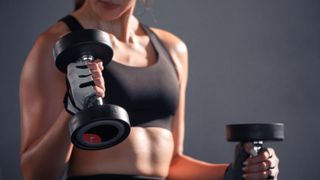 a woman performing dumbbell curls