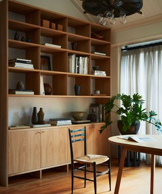 dining room with wooden floor and shelving unit and oval wooden table