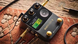 A Singular Sound BeatBuddy 2 drum machine pedal on a rug