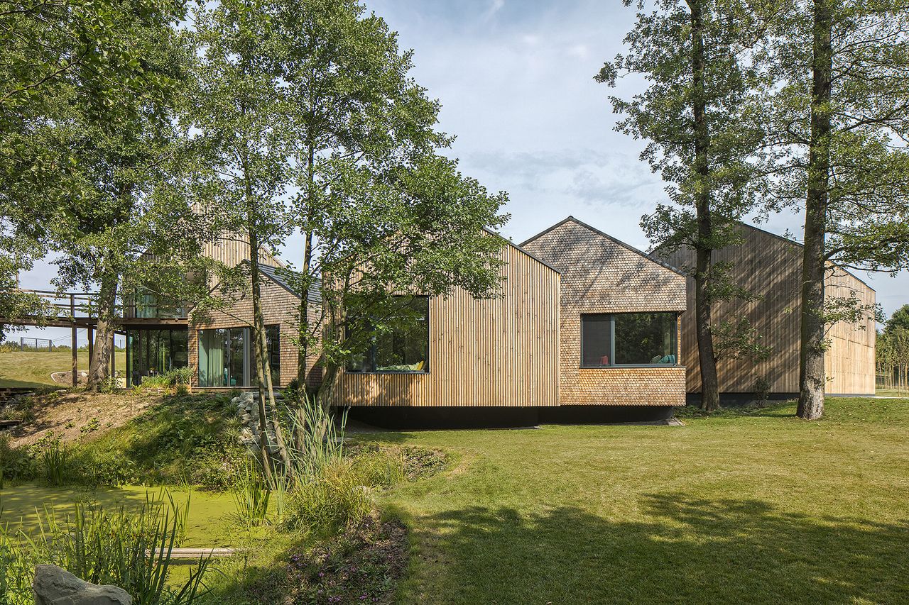 A multi-building Polish farmhouse surrounded by greenery 