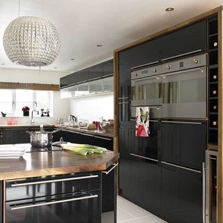 kitchen with glossy black wall and extractor hood