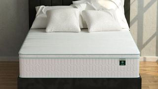 A Zinus Hybrid mattress on a bed frame in a bedroom
