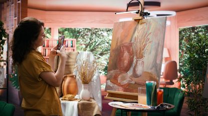 Woman takes photo of her rustic work of art