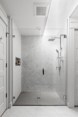 marble herringbone shower room by Interiors by Popov