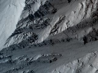 A swath of collapsed ground at the edge of Olympus Mons, the highest volcano on Mars. The image was taken by NASA's Mars Reconnaissance Orbiter.