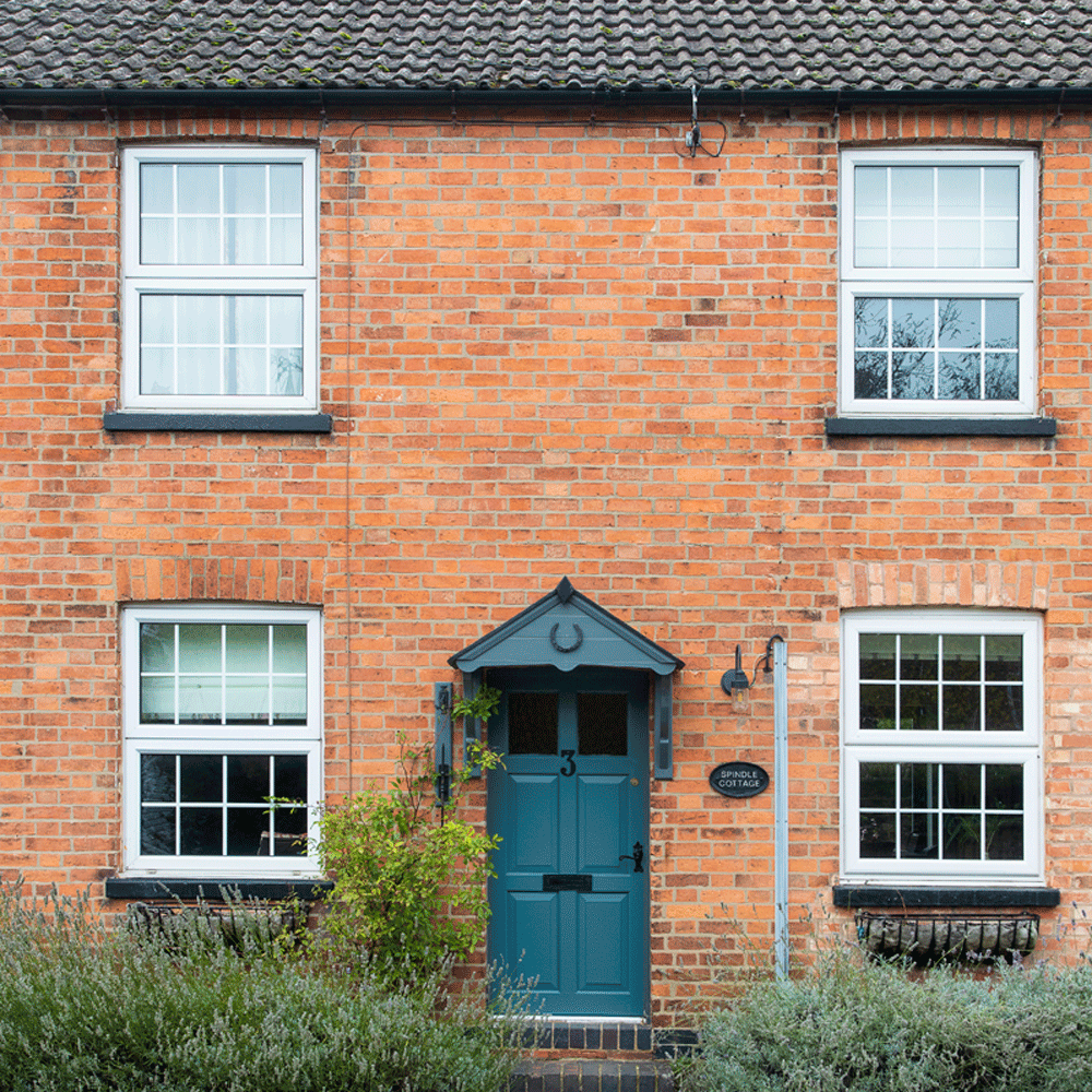 house exterior with brick walls and sash windows