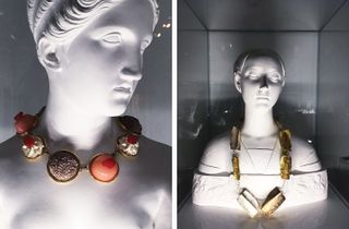 Large decorative necklaces on stone busts