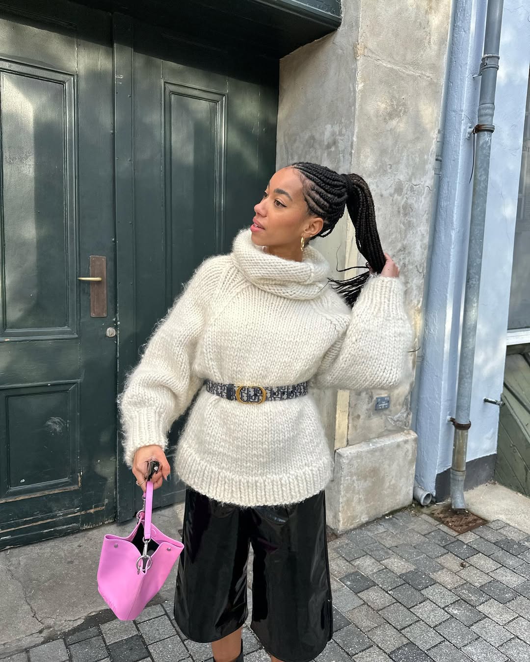 Amaka Hamelijnck wears straight back braids in a high ponytail