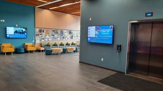 A lobby on a college campus with digital displays powered by Carousel digital signage.