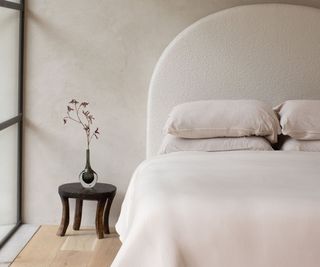 Shleep Luxury Merino Wool Bedding on a bed against a white wall.