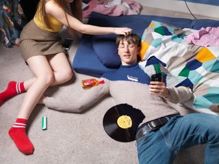 "I’ve photographed a range of ages for this project, and the idea of recreating a messy teenager’s bedroom appealed to me. I prepared by posing a model in a jumper covered in gaffer tape. I added accessories around him, drawing matching lines on the taped jumper. I then photographed the annotated top and marked it up with color indications. This gave me a model to brief the knitter, allowing precise placement of lines to match the accessories."