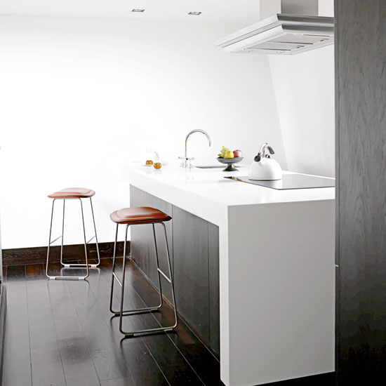 orange leather stool with white wall and sink