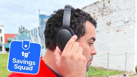 a photo of the reviewer wearing the bose quietcomfort headphones with a tom's guide savings squad badge