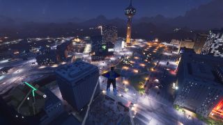 Flying over a city at night with a wingsuit