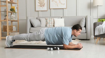 Man doing a plank in his living room